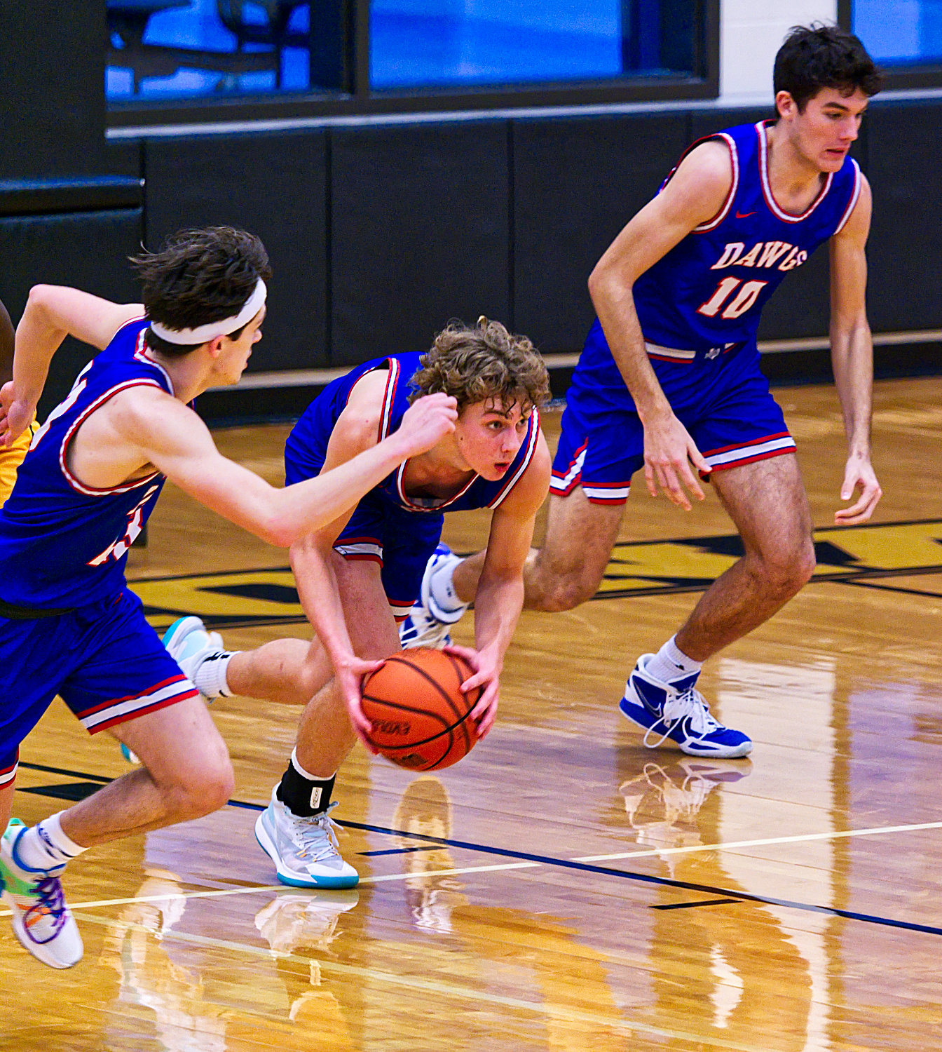 Brady Floyd starts the fast break flanked by Levi Thompson and Ethan Presley. [see more shots, buy basketball photos]